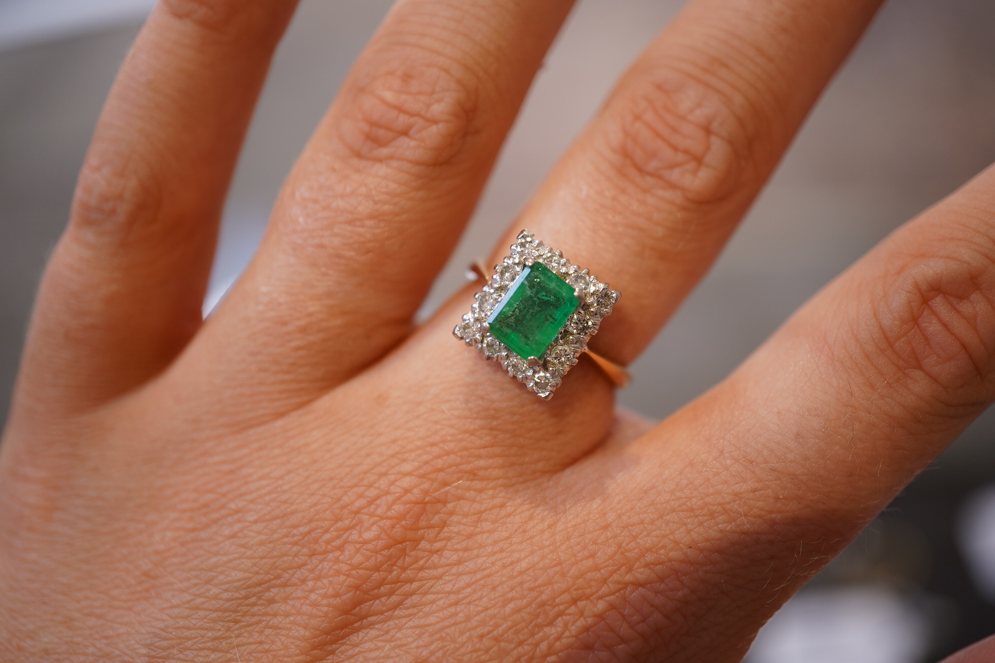 An emerald and diamond ring